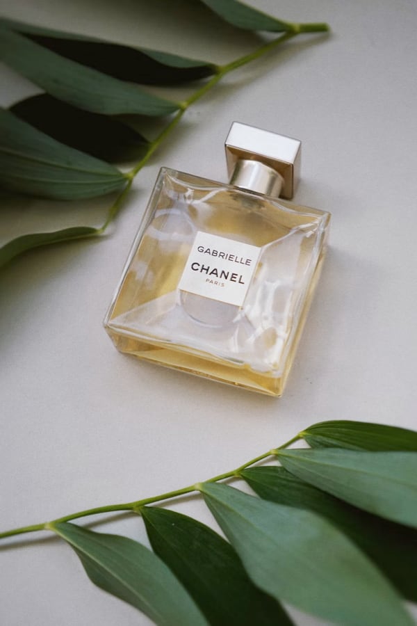 perfume with leaves around it